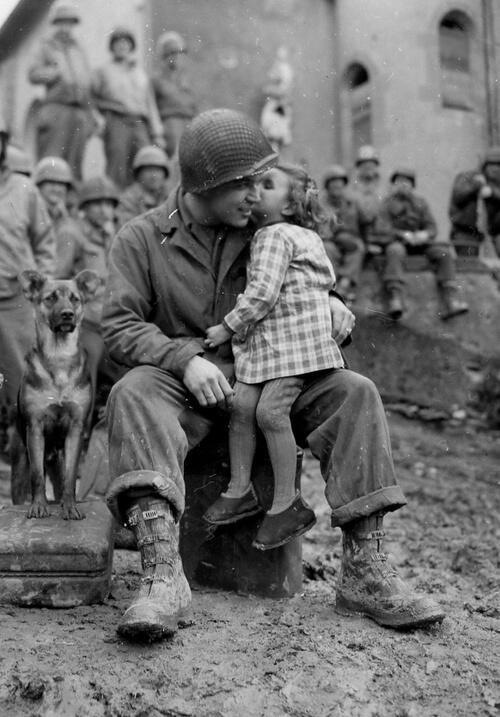 9th Armored Division technician with a little French girl on Valentine’s Day - 1945