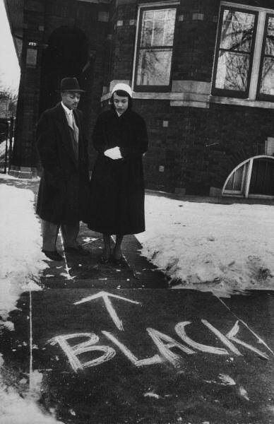Chicago, 1957 - una coppia di colore che si trasferisce in un quartiere tutto bianco che guarda le scritte razziste di fronte a casa