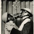 Coppia con maschera a gas si bacia sotto il vischio. Inghilterra 1940