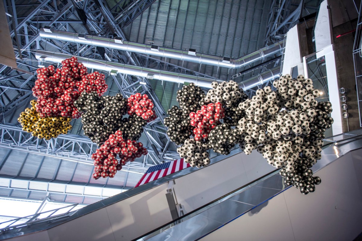 Darío Escobar - “Obverse & Reverse (Black, white, red and gold)” (2016), leather, string, pigments, stainless steel, polyestyrene, gold leaf,177 x 354 x 157 inches. Photo credit: Justin Chan, courtesy of the artist and Nils Stærk Gallery