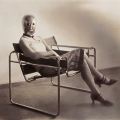Una donna non identificata che indossa una maschera di Oskar Schlemmer, seduta in una sedia Wassily di Marcel Breuer, c. 1926