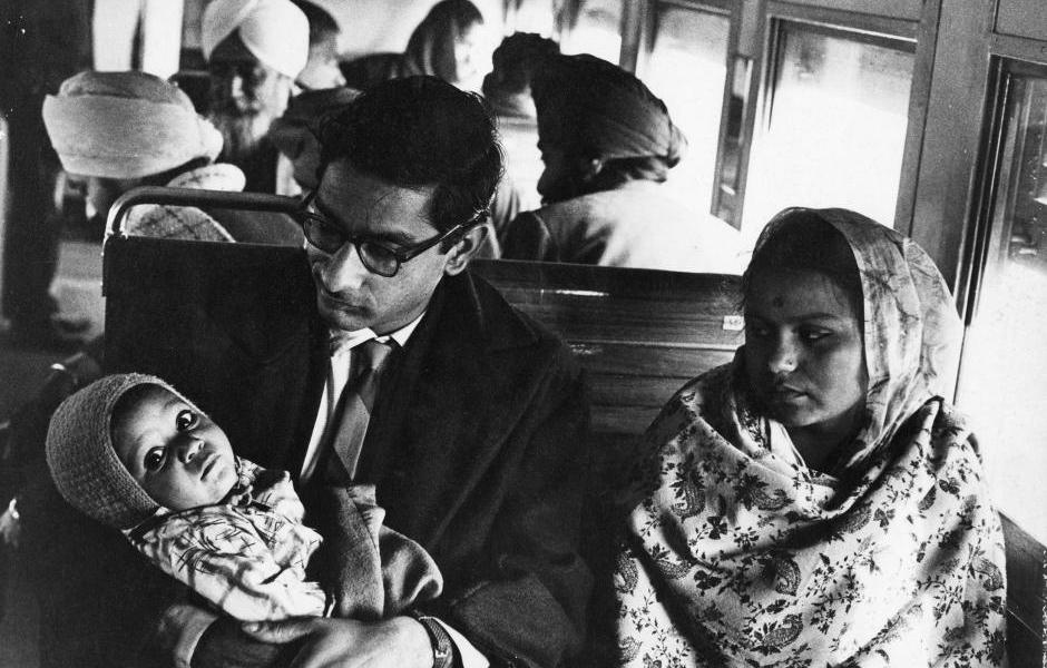 Museum number PHY.07736 T. S. Satyan, Young couple and baby on a train journey, 1970, H. 26.6 cm, W. 35.3 cm, Silver gelatin print