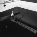 Richard Wilson, standing in the original installation of 20.50, Matt_s Gallery, London, 1987. Photography by Edward Woodman