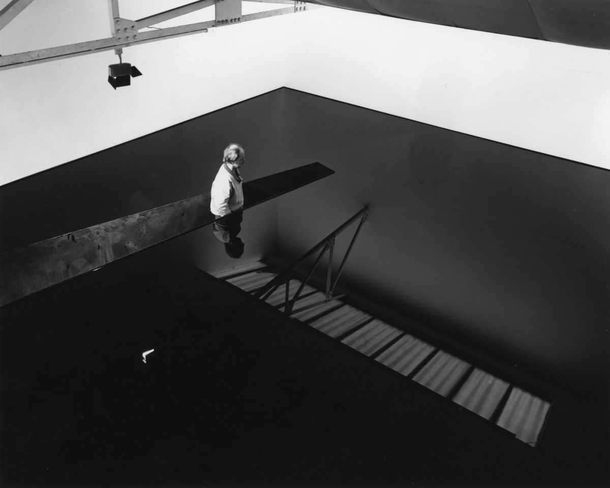 Richard Wilson, standing in the original installation of 20.50, Matt_s Gallery, London, 1987. Photography by Edward Woodman
