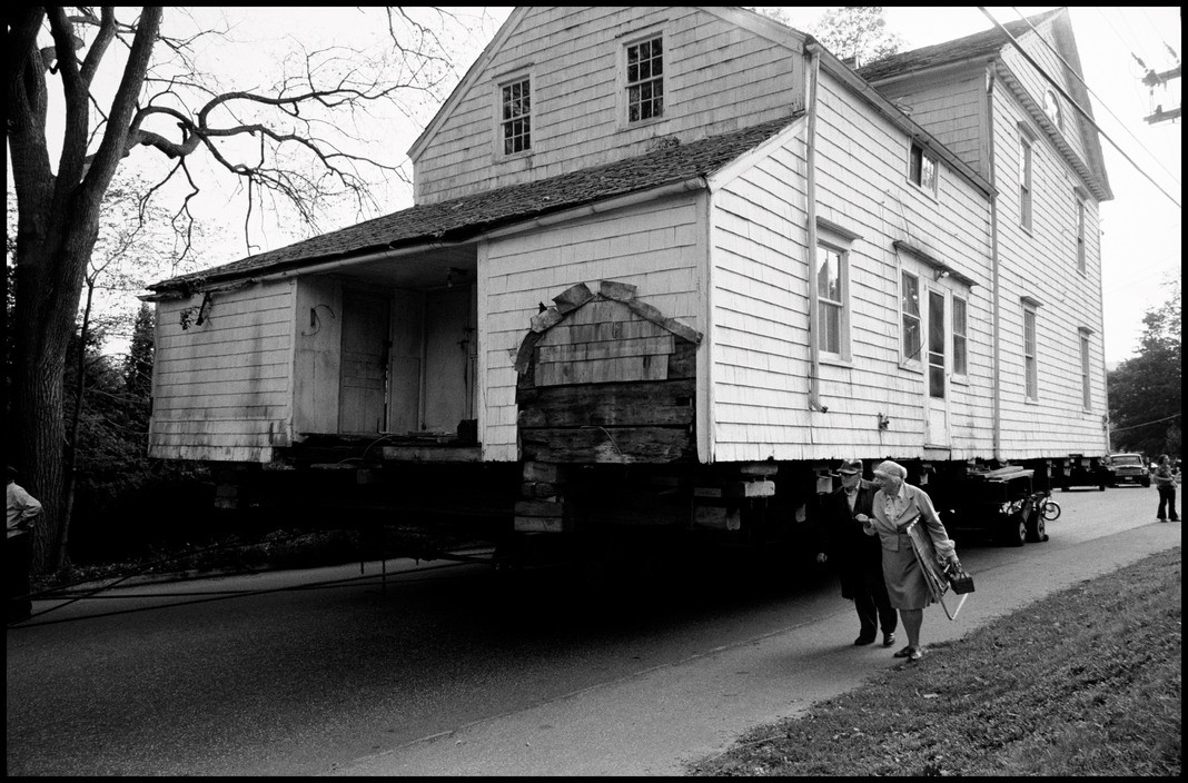 USA. CT. Shelton. Elderly couple walking away from the house they just donated to the Historical Society.