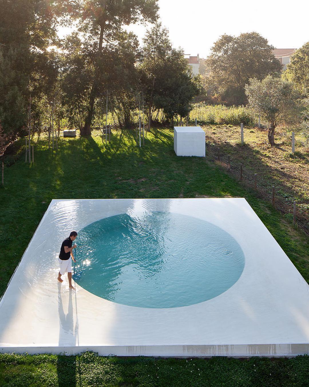 Architect Guilherme Machado Vaz takes influence from the early modernist movement with the "Afife House" in northern Portugal. The residence faces away from the road and toward an artfully planned swimmingpool in the yard. Photography by Jose Campos