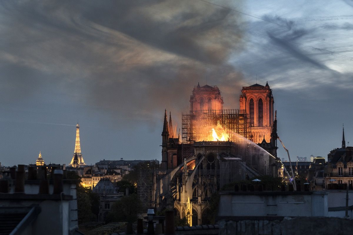 PARIS, FRANCE - APRIL 15: Flames and smoke are seen billowing from the roof at Notre-Dame Cathedral on April 15, 2019 in Paris, France. A fire broke out on Monday afternoon and quickly spread across the building, collapsing the spire. The cause is yet unknown but officials said it was possibly linked to ongoing renovation work. (Photo by Veronique de Viguerie/Getty Images)