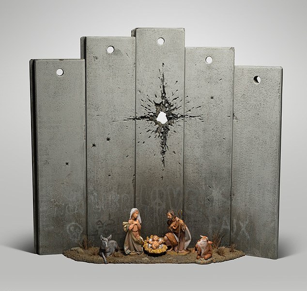The 'Scar of Bethlehem' (pictured) features a nativity scene with Mary and Joseph and the baby Jesus - but instead of a star hanging over the crib, there is what appears to be a large bullet hole piercing an imposing grey wall