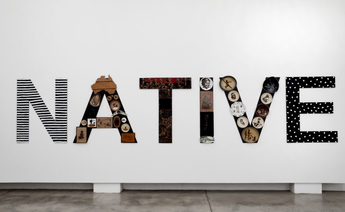 Tony Albert NATIVE, 2019, acrylic and found vintage objects applied to plastic-polyester, powder-coated aluminium, 120×550 cm, courtesy l’artista e PAC