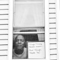 Robert E. Clark Jr. poses for ‘Words At The Window: Self Isolation And The Coronavirus’, a portrait series by Shutterstock Staff Photographer, Stephen Lovekin, shot around the Ditmas Park neighborhood of Brooklyn, New York.