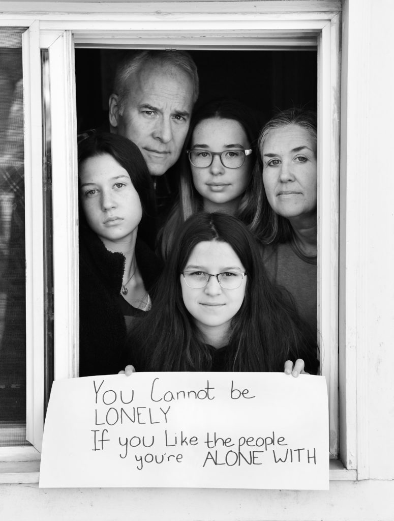 Tom Smith and Laura Ross, with daughters Caroline, Elizabeth, and Abigail, pose for 'Words At The Window: Self Isolation And The Coronavirus', a portrait series by Shutterstock Staff Photographer, Stephen Lovekin, shot around the Ditmas Park neighborhood of Brooklyn, New York.