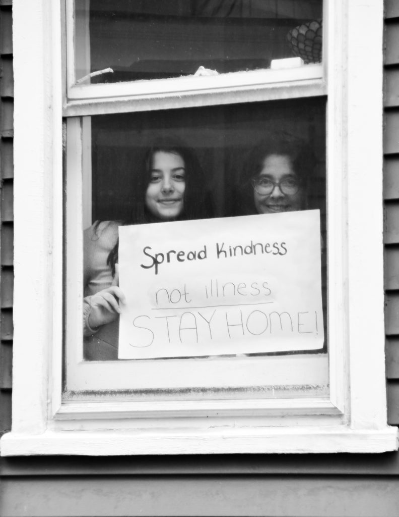 Anna Beth Rousakis and daughter Mary Rousakis pose for 'Words At The Window: Self Isolation And The Coronavirus', a portrait series by Shutterstock Staff Photographer, Stephen Lovekin, shot around the Ditmas Park neighborhood of Brooklyn, New York.