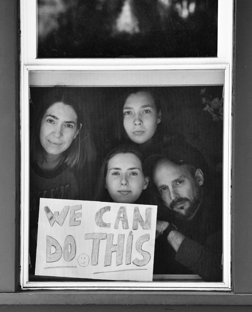 Lisa Draho and Josh Zuckerman, with children Ruby and Ava, pose for 'Words At The Window: Self Isolation And The Coronavirus', a portrait series by Shutterstock Staff Photographer, Stephen Lovekin, shot around the Ditmas Park neighborhood of Brooklyn, New York.