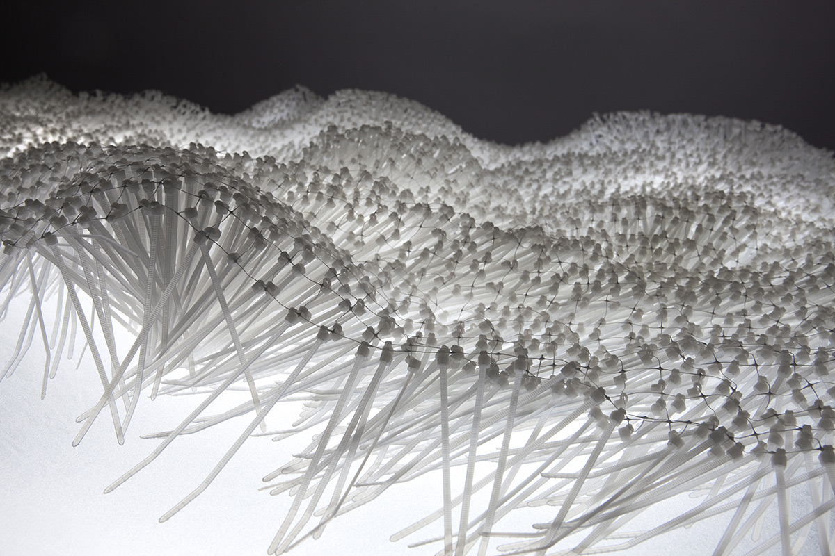 Elisabeth Picard. “Flot” (2011),
15, 000 zip-ties, glass, painted steel, and fluorescent light,
28.25 x 76.5 x 38.5 inches. Photo by Michel Dubreuil