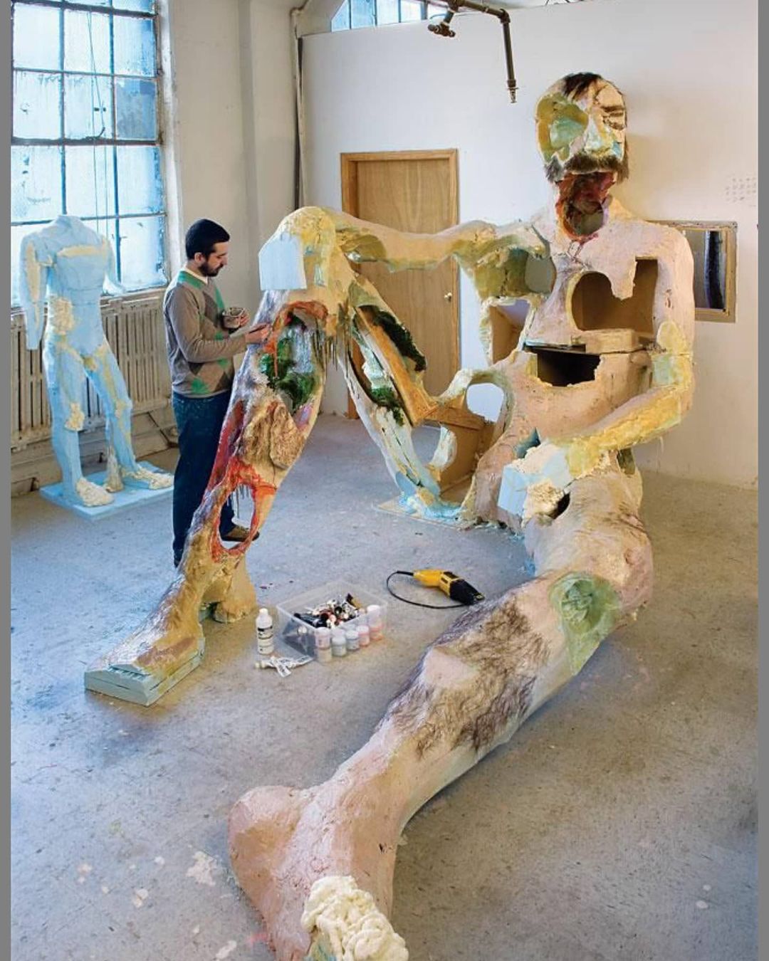 David Altmejd working on The Giant 2 in 2007; the sculpture is constructed out of bronze, steel, taxidermied birds, quartz, feathers and other materials. Photo by Ellen Page Wilson courtesy of Andrea Rosen Gallery, New York, and Stuart Shave/Modern Art, London
